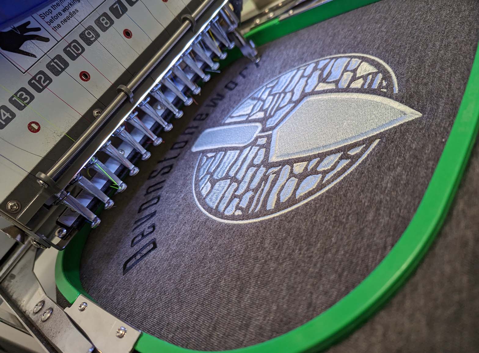 A photograph of the Fine Stitch Embroidery machines working at the Clothing Your Way production studio in Paignton, South Devon.