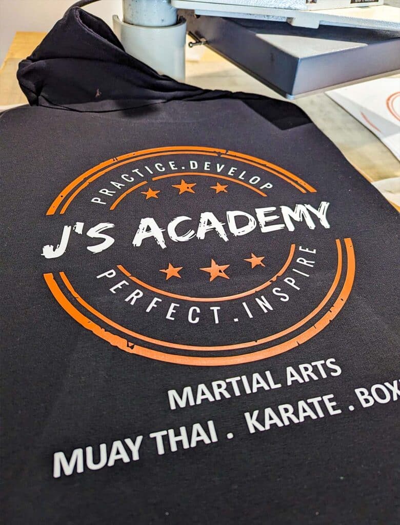 A photo of the Full Colour Vinyl Print process for a job for J's Academy, completed by Clothing Your Way in Paignton, South Devon.